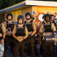 Police stand guard as demonstrators, marking the one-year anniversary of the fatal police shooting of Michael Brown, protest along West Florissant Street Aug. 10, 2015, in Ferguson, Mo.
Scott Olson/Getty Images